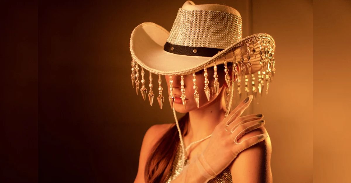 Classic western disco outfit with silver disco cowboy hat, fringe jacket, and denim at a music festival