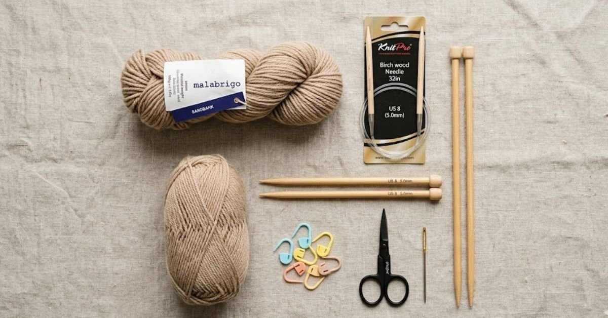 Knitting supplies for beginners including yarn needles and tools for how to knit a hat